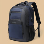 A navy blue and black BANGE backpack with multiple zippered compartments, a side mesh pocket, and padded shoulder straps, shown on a solid beige background.