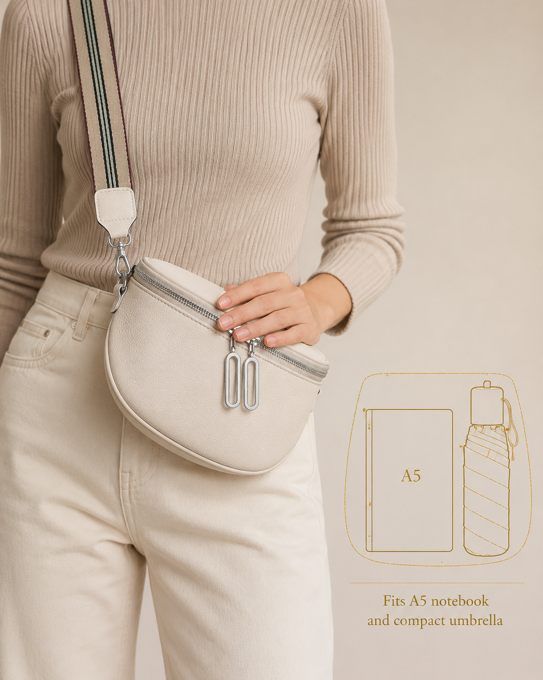 A person wearing a beige ribbed sweater and cream pants carries a small oval crossbody bag in a matching light beige tone. The bag has a wide shoulder strap with dark green and light blue stripes, silver zipper hardware, and a white fabric loop.